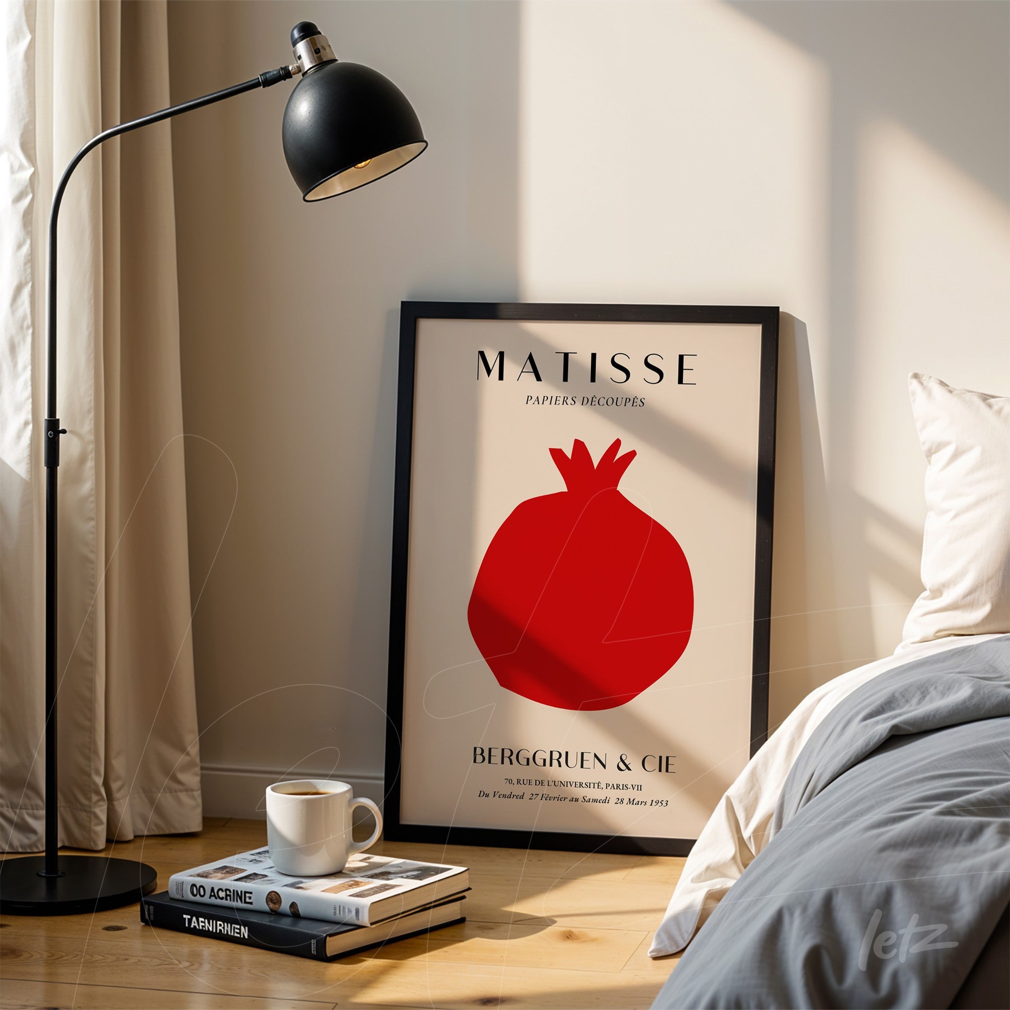 quadro decorativo com arte abstrata de romã em moldura preta, exposto ao lado de um abajur em ambiente iluminado
