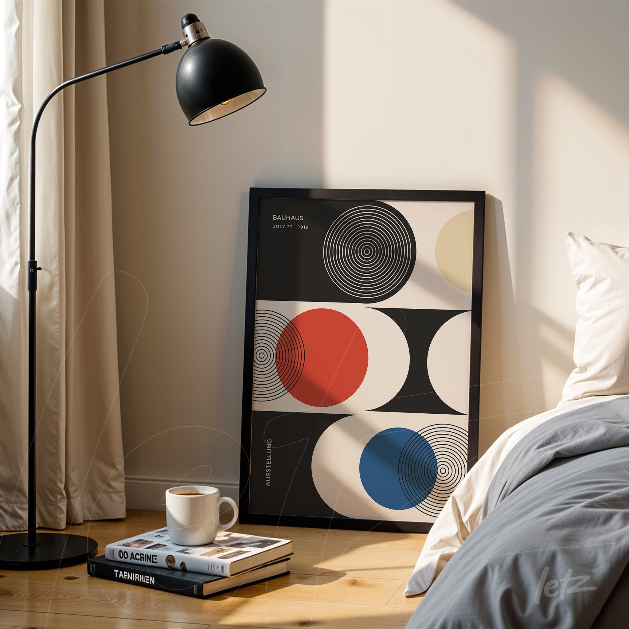 quadro gráfico inspirador com formas geométricas em cores preto, vermelho, azul e creme, em moldura preta, apoiado junto a livros e luminária em ambiente aconchegante