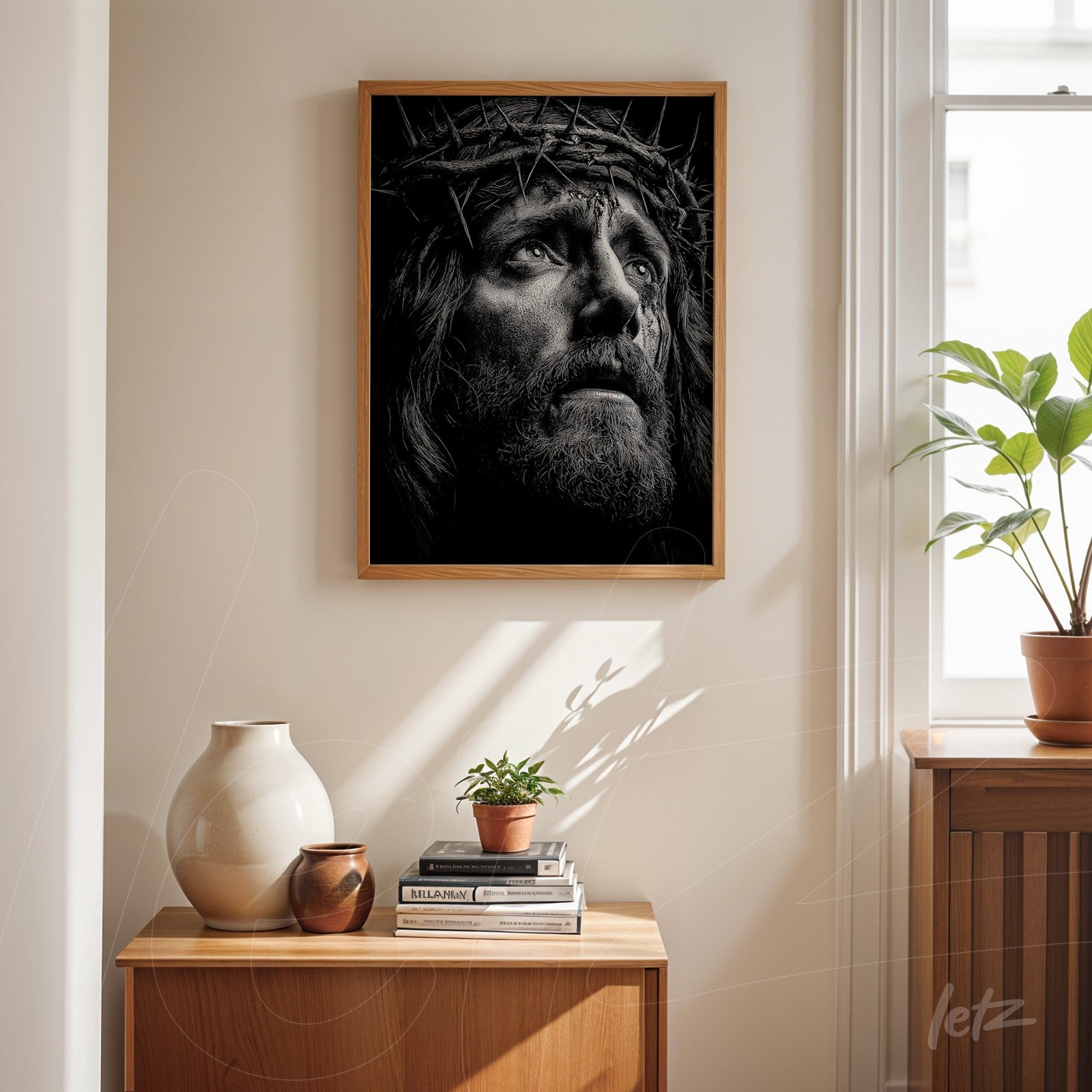 quadro em moldura de madeira clara com retrato em preto e branco de Cristo coroado de espinhos, exibido sobre uma mesa de madeira em ambiente iluminado
