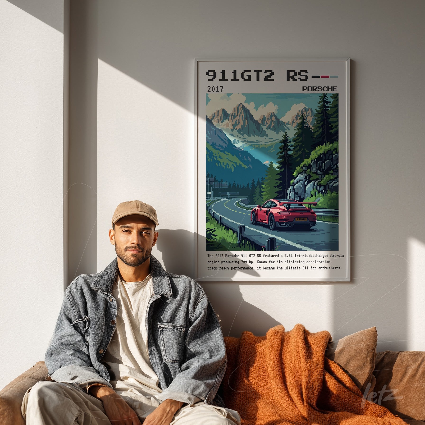 quadro emoldurado com arte pixelada de um Porsche 911 GT2 RS, exposto em parede clara, com um homem sentado ao lado em ambiente aconchegante