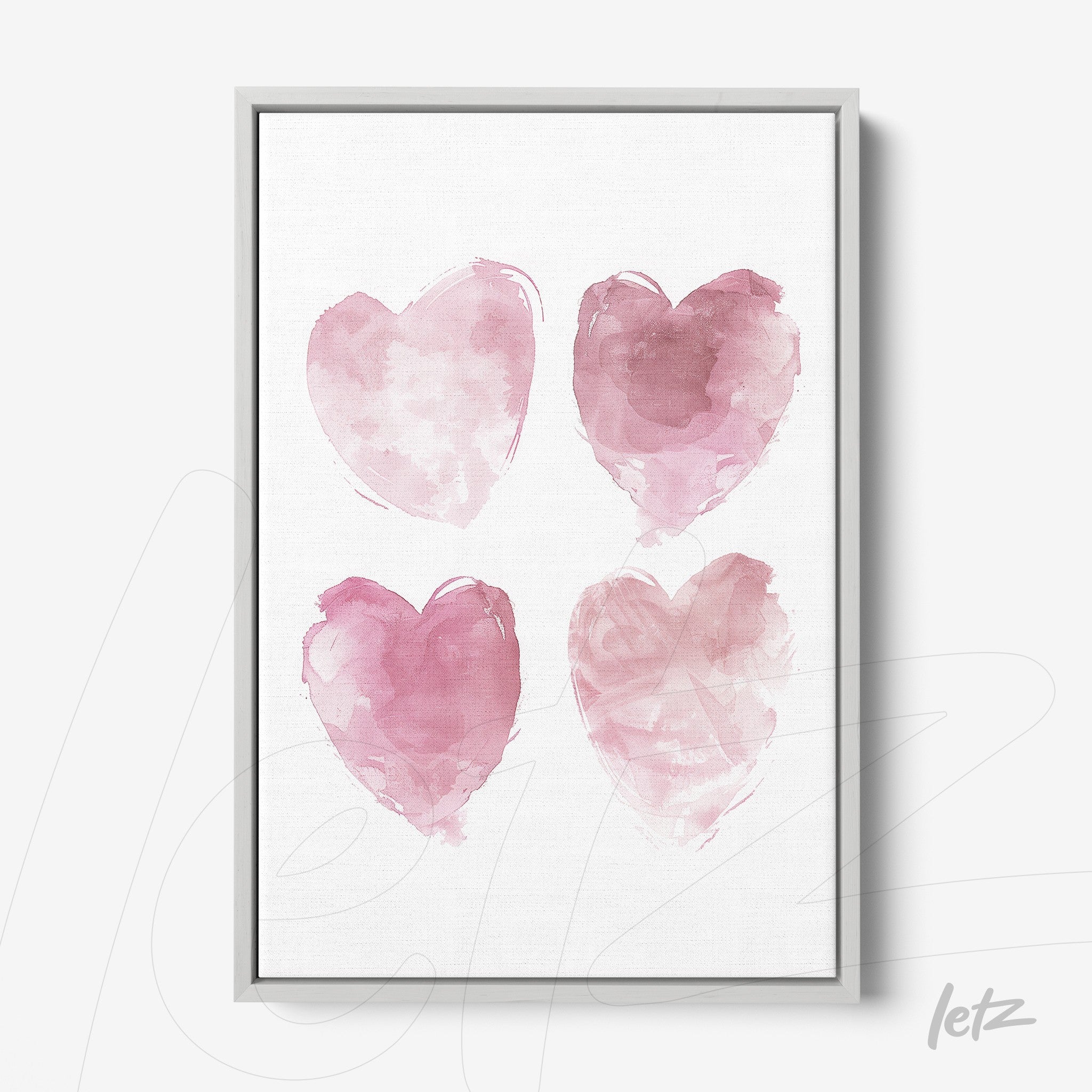 quadro decorativo com quatro corações em aquarela nas tonalidades de rosa em moldura prata