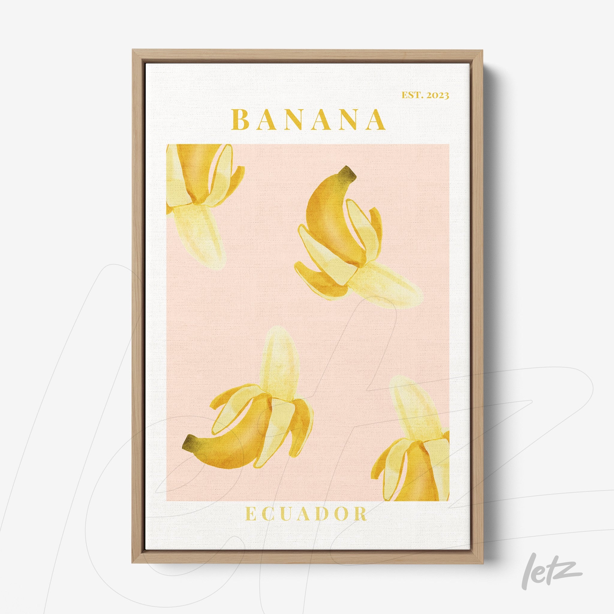 quadro em moldura de madeira clara com arte de bananas em fundo rosa e texto em amarelo
