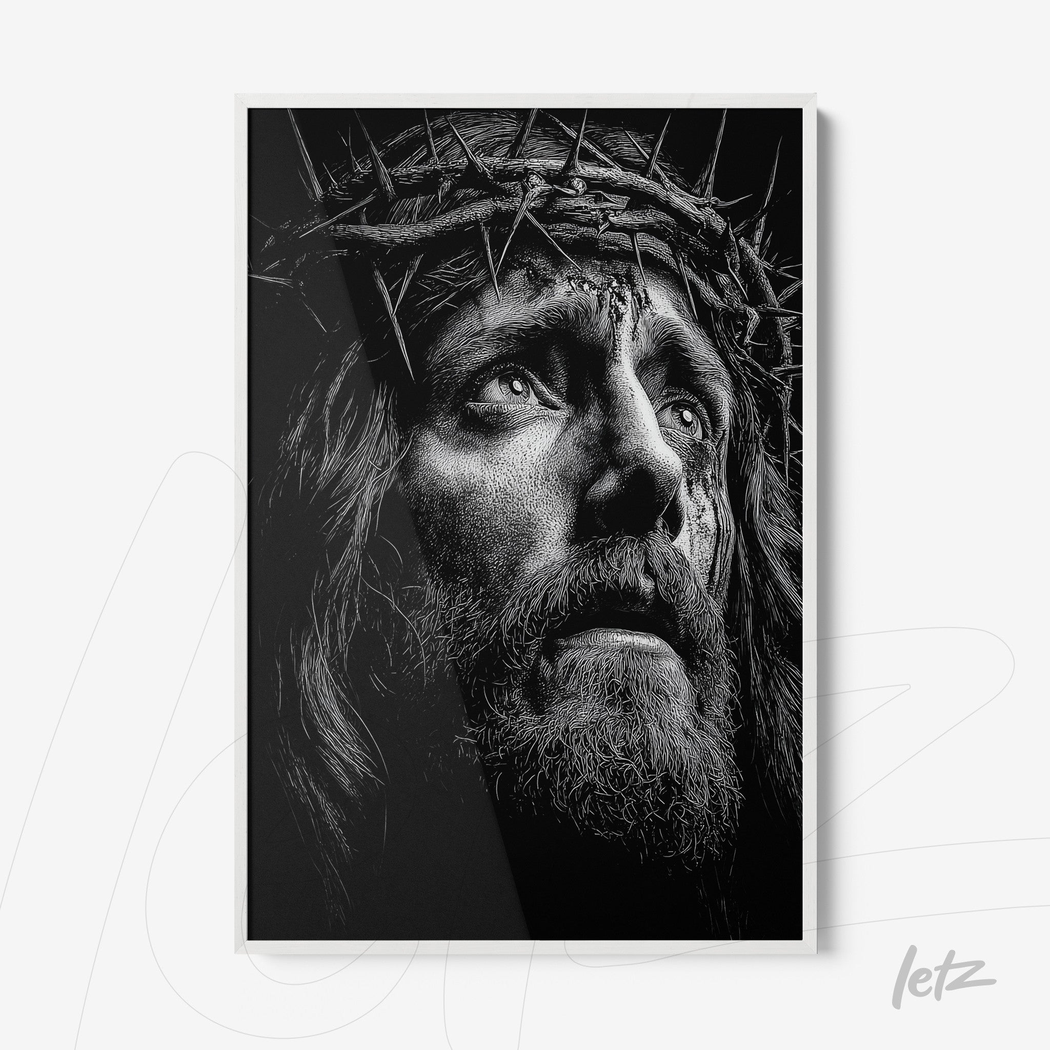 quadro em preto e branco retratando o rosto de Jesus com coroa de espinhos em moldura branca