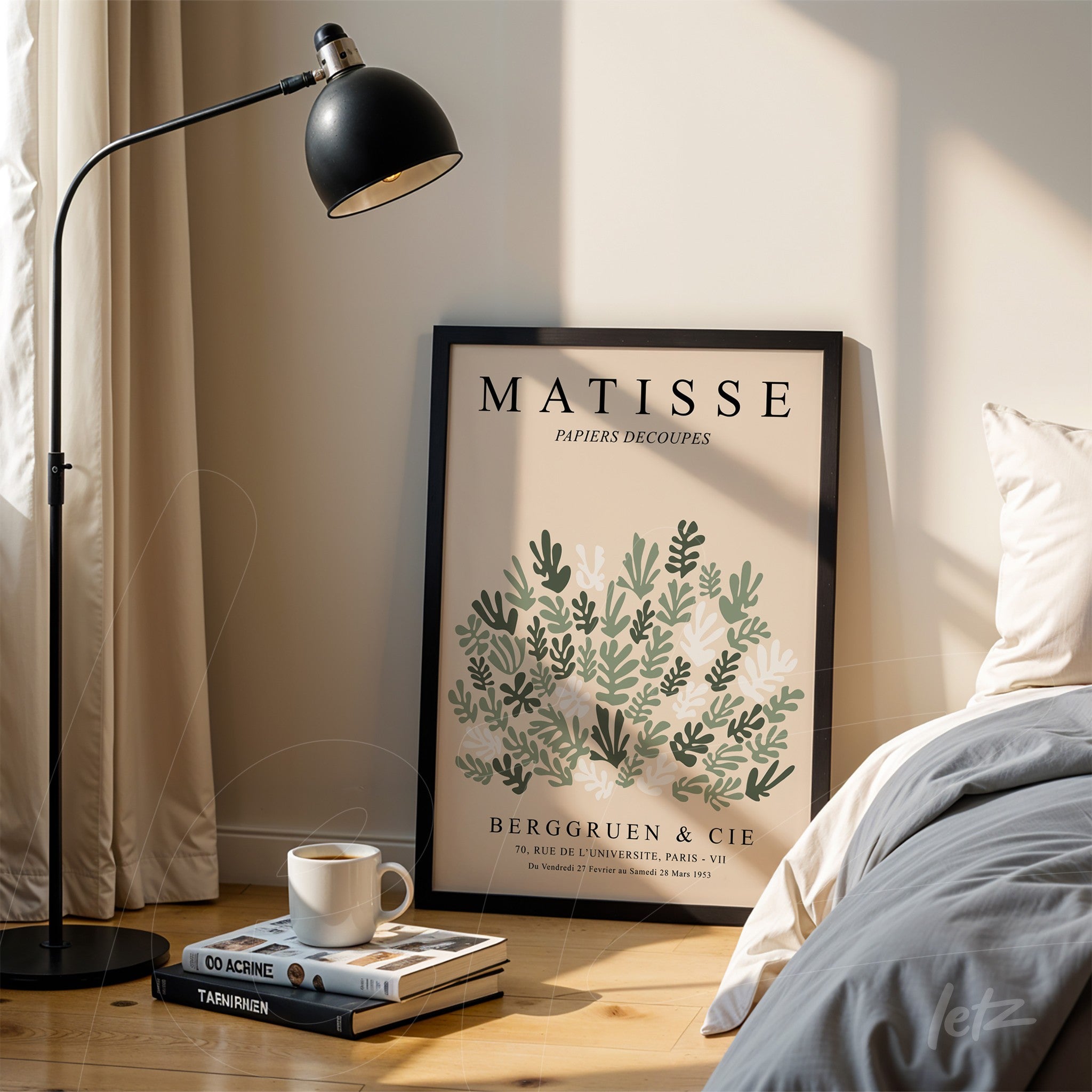 quadro com arte moderna de matisse em moldura preta com folhas verdes e brancas apoiado ao lado de um abajur em ambiente claro