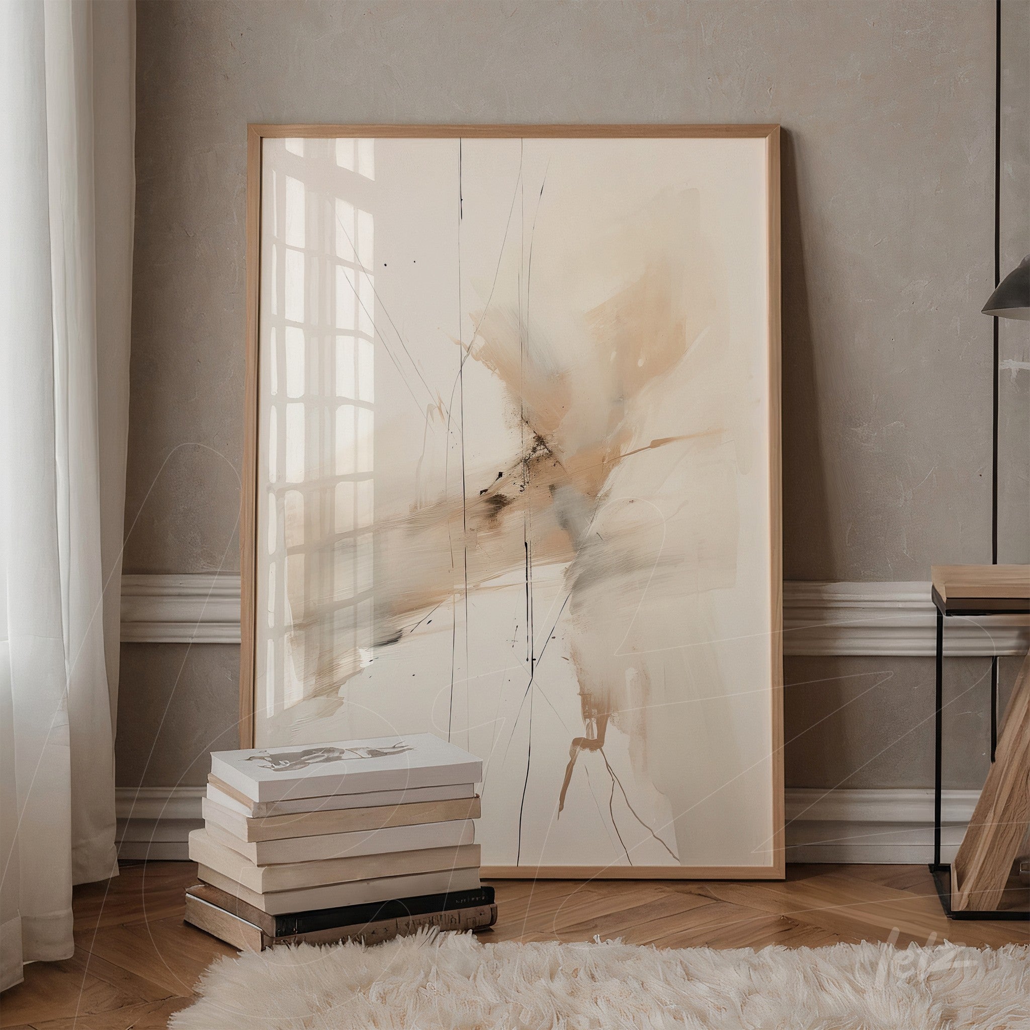 quadro abstrato com tons terrosos em moldura de madeira clara, apoiado ao lado de uma pilha de livros em ambiente com parede clara