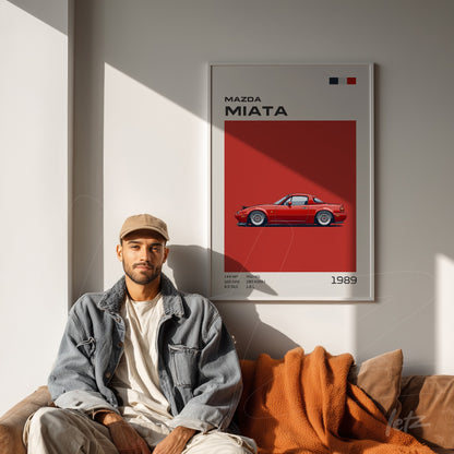 quadro com ilustração do carro Mazda Miata de 1989 em moldura branca sobre parede vermelha