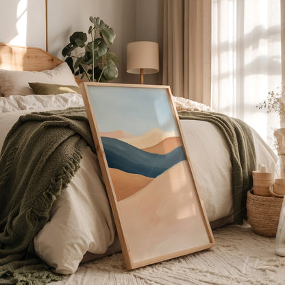 quadro com arte abstrata em tons de azul e bege em moldura de madeira exposto em quarto com cama e decoração suave