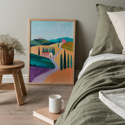 quadro decorativo com paisagem campestre em moldura clara, exibido ao lado de uma cama com colcha verde e travesseiros claros