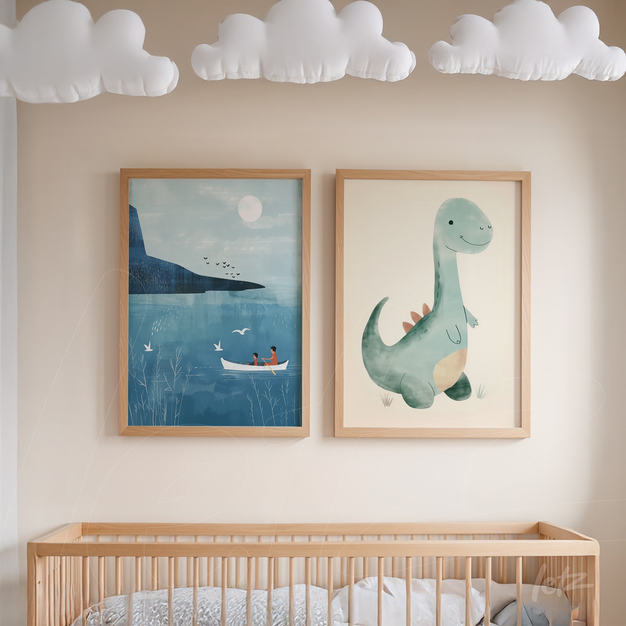 quadro com ilustração de dinossauro verde em moldura clara ao lado de arte de paisagem azul com barcos em moldura de madeira clara sobre parede neutra