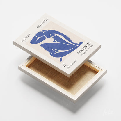 quadro em canvas com arte do nu feminino em azul sobre fundo claro, moldura branca