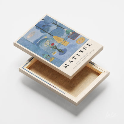 quadro em canvas com arte de Henri Matisse, apresentando uma composição de formas azuis e amarelas sobre fundo claro, moldura natural