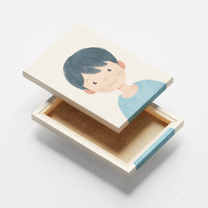 quadro em canvas com ilustração de menino com cabelo escuro e blusa azul, moldura em madeira clara