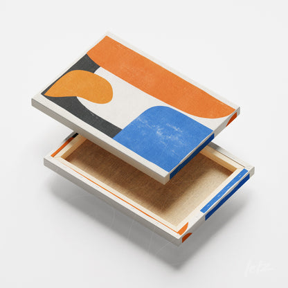 quadro em canvas com design abstrato em tons de laranja, azul e preto sobre fundo branco