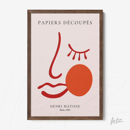 quadro com arte moderna representando um rosto em tons de vermelho e rosa com moldura de madeira escura