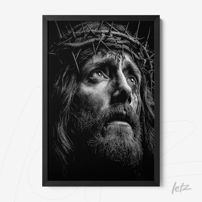 quadro com arte em preto e branco retratando um rosto pensativo de Jesus com coroa de espinhos em moldura preta