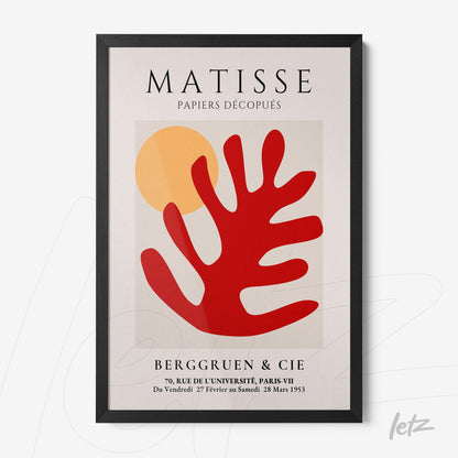 quadro com arte moderna em cores vibrantes, destacando formas geométricas e uma folha estilizada em vermelho sobre fundo claro, moldura preta