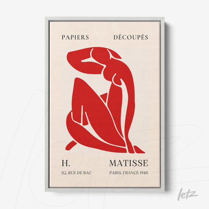 quadro com arte recortada de figura feminina em vermelho sobre fundo claro, moldura prata