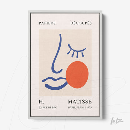 quadro com arte de linhas abstratas em cores vibrantes, apresentando uma figura estilizada com um rosto feminino e um círculo vermelho, moldura metálica prateada