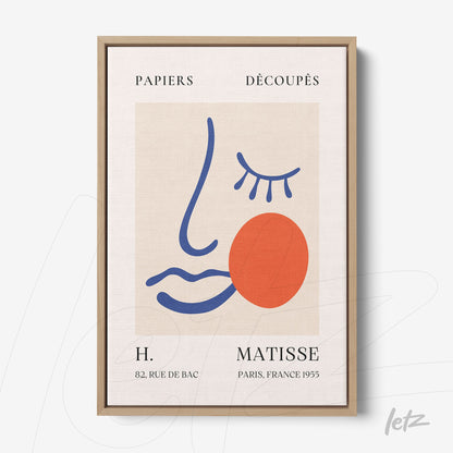 quadro de arte contemporânea com desenho abstrato de rosto e formas coloridas em moldura de madeira clara