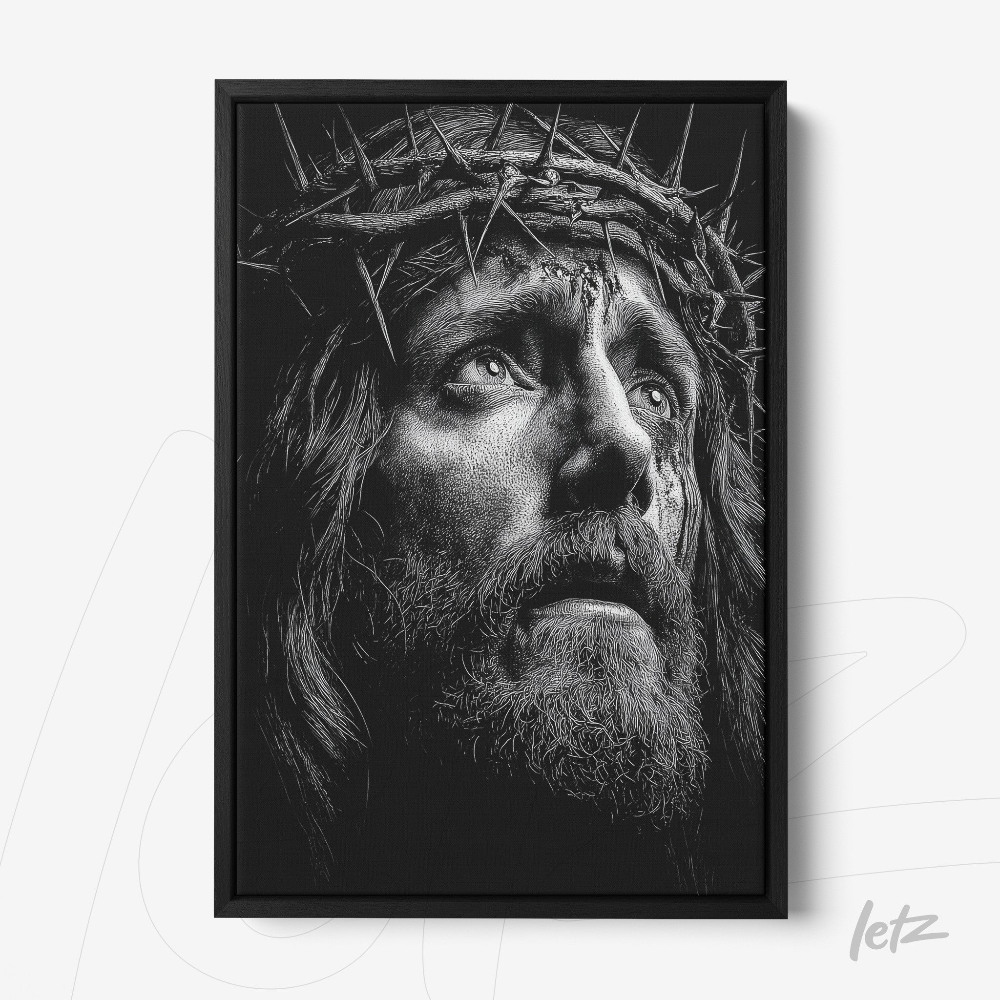 quadro em preto e branco com retrato de Jesus Cristo usando coroa de espinhos em moldura preta