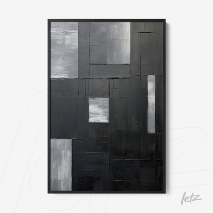 quadro abstrato em preto e cinza com várias texturas em moldura preta