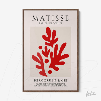 quadro com arte em estilo moderno apresentando formas vermelhas sobre fundo claro, rodeado por moldura de madeira escura